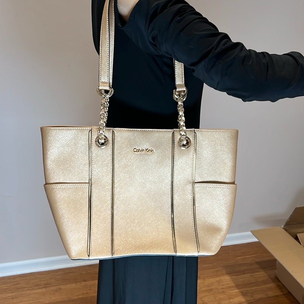 NWOT Pale gold colored Calvin Klein purse with gold metal accents.